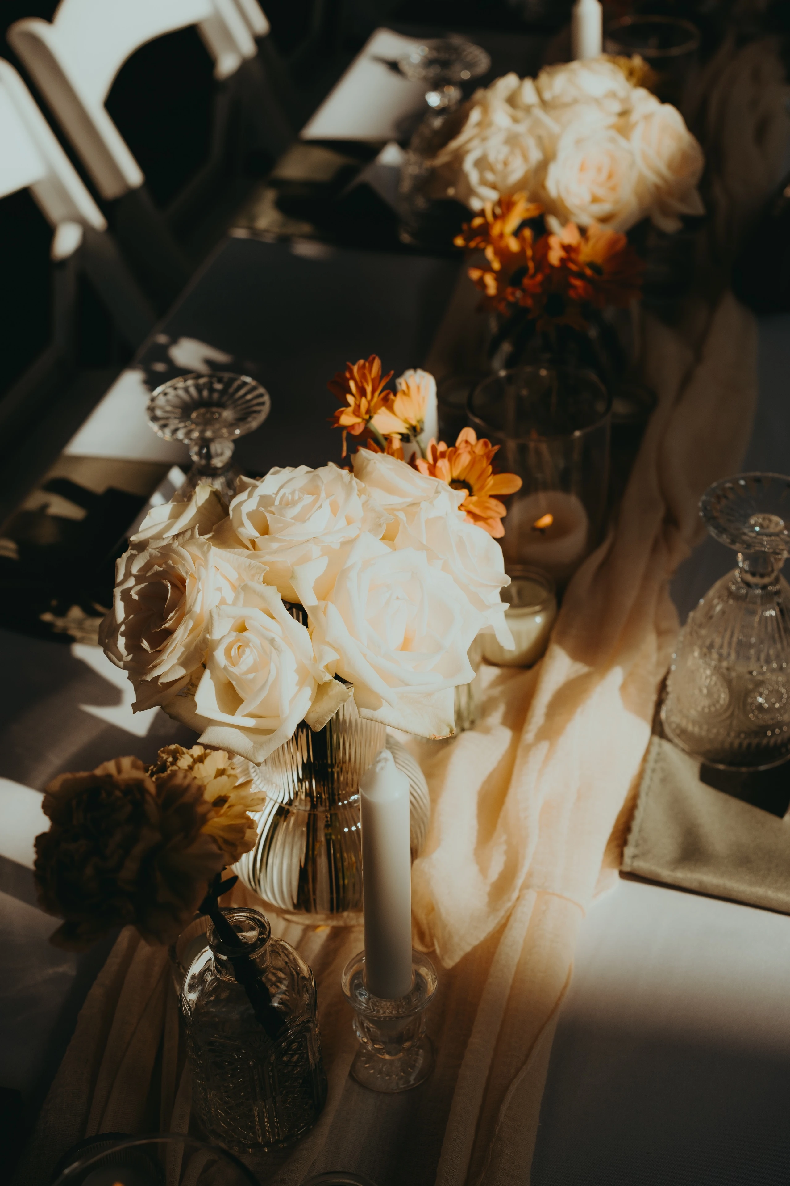 Floral centerpiece and candlelight details at a Toronto celebration, photographed before guests arrive
